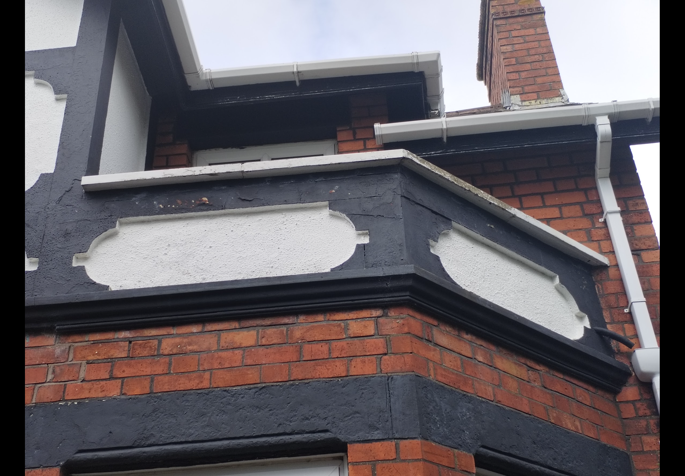 Exterior painting Bangor — close-up of decorative render detail showing deterioration before repainting