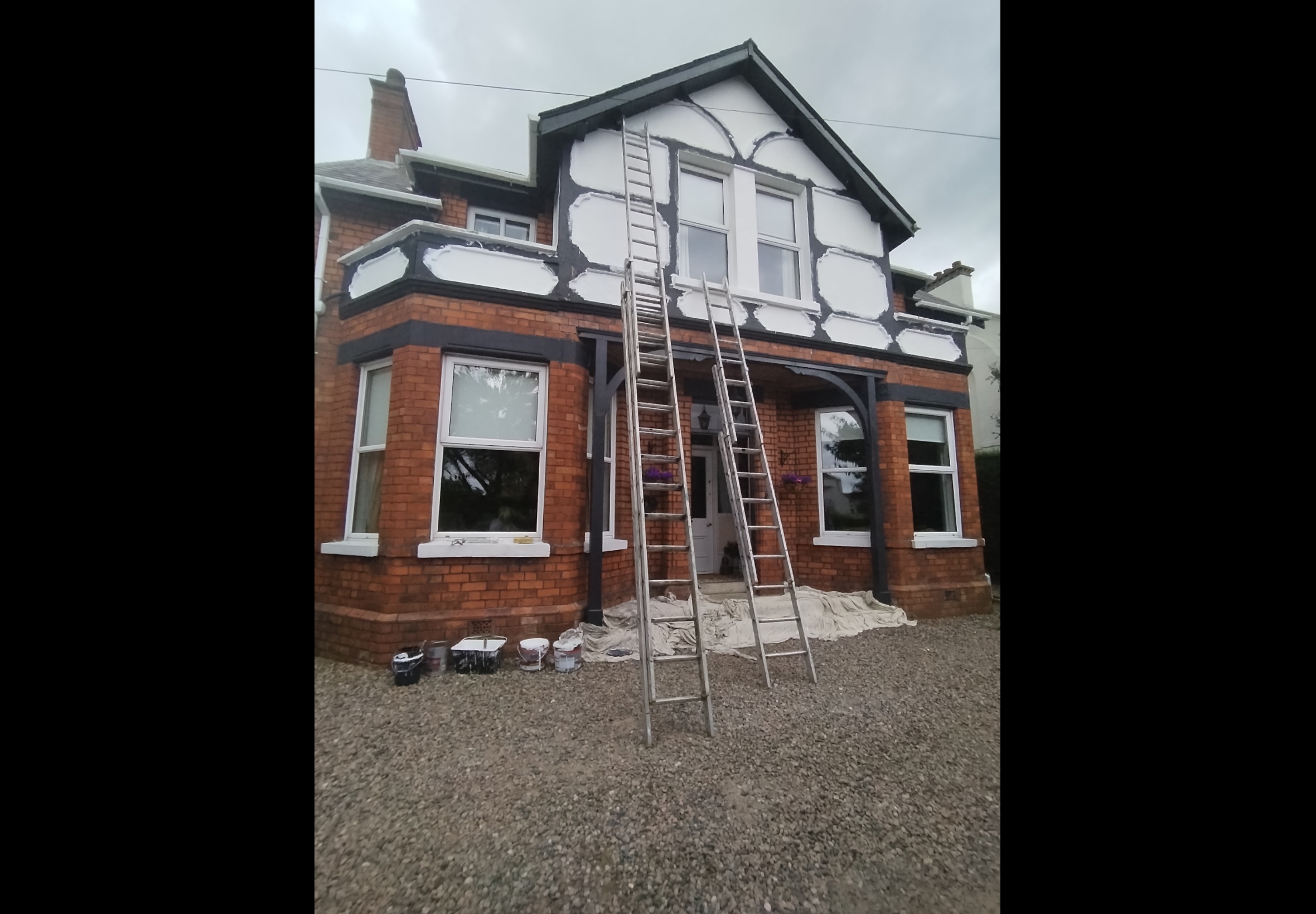 Exterior restoration Bangor — full property view during preparation with ladders and access equipment in place