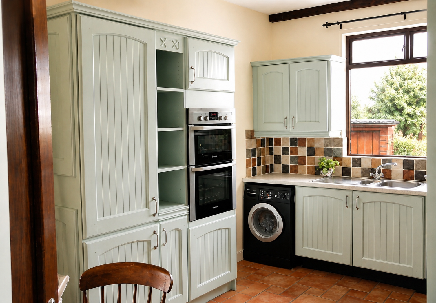 Pine kitchen with exposed beams after hand painting in sage green